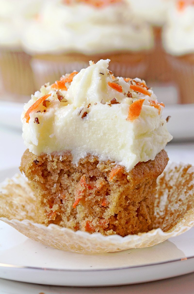 Moist carrot cupcakes with coconut pineapple cream cheese frosting, bakery-style, ready to serve.