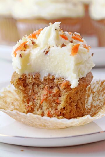 Moist carrot cupcakes with coconut pineapple cream cheese frosting, bakery-style, ready to serve