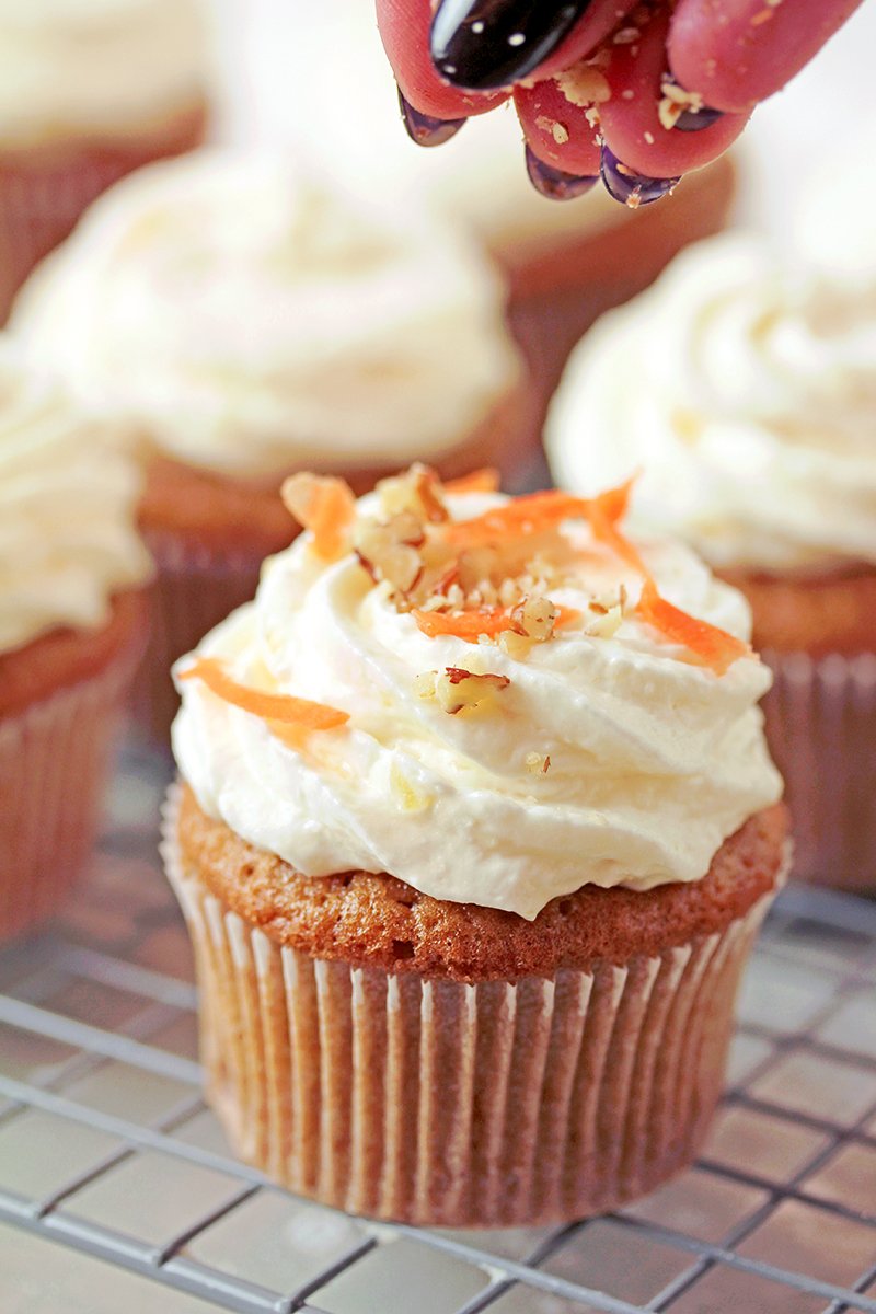 Moist carrot cupcakes with coconut pineapple cream cheese frosting, bakery-style, ready to serve.