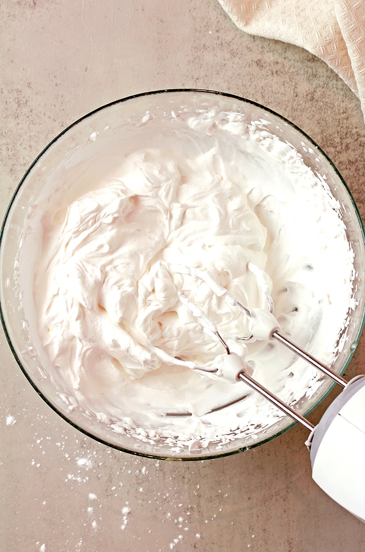 Heavy cream being whipped to stiff peaks.