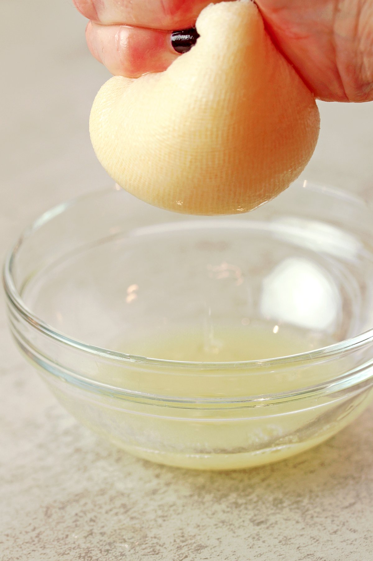 Pineapple being processed and drained for coconut pineapple cream cheese frosting.