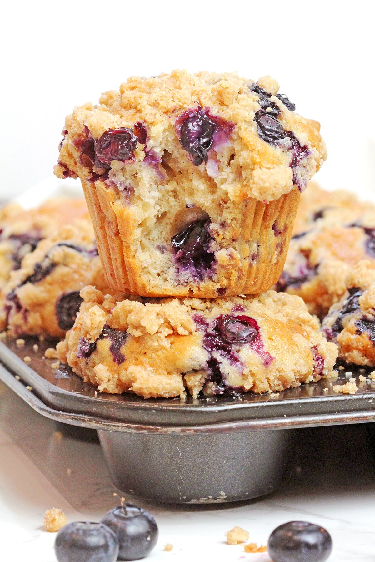 These easy banana blueberry muffins with crumb topping have everything you could want in a homemade muffin recipe - soft banana-flavored centers, bursts of fresh blueberries, crunchy walnuts, and a generous layer of buttery cinnamon streusel.