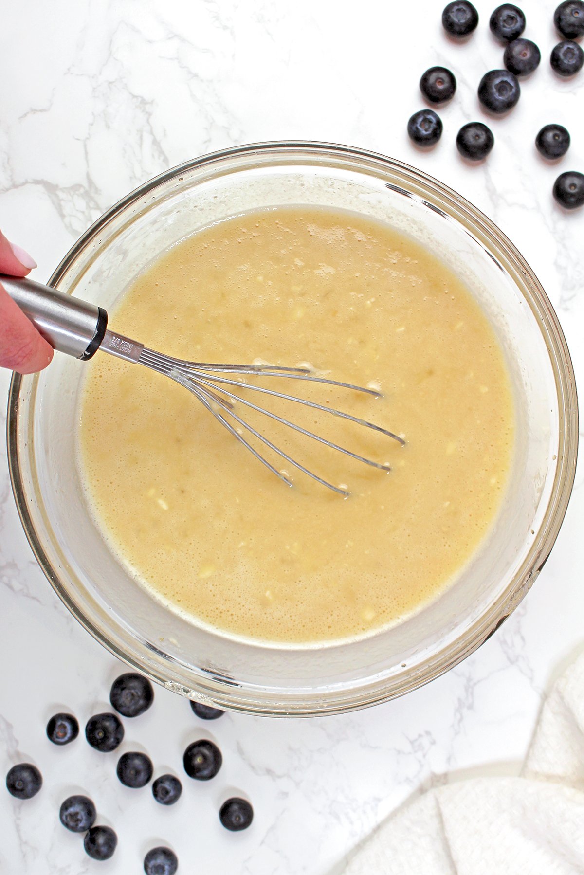 In a large bowl, whisk together vegetable oil, brown sugar, and granulated sugar. Add eggs, vanilla extract, and sour cream and whisk until smooth. Stir in the mashed bananas.