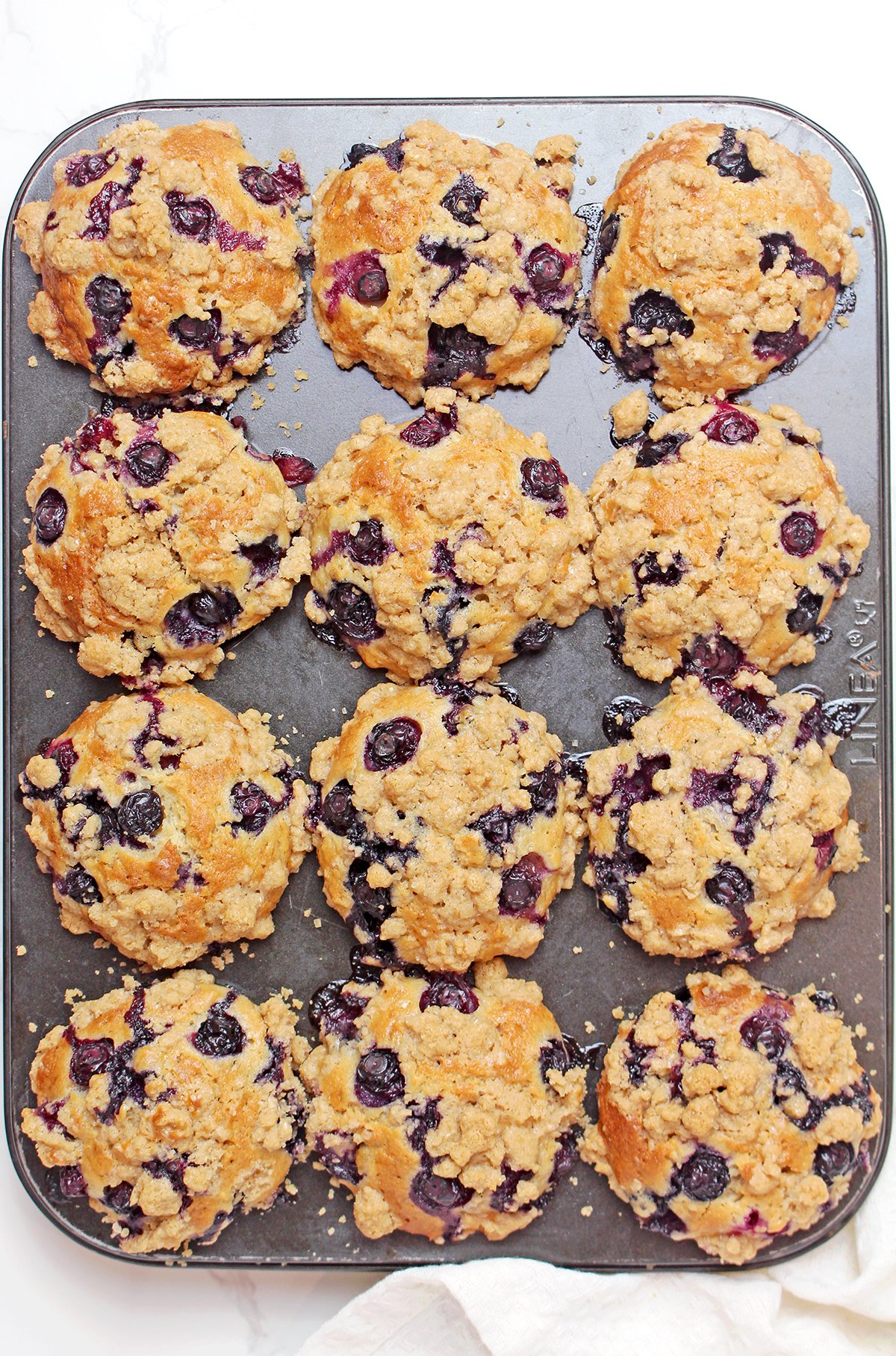 Bake for 25–30 minutes, or until the tops are golden brown and a toothpick inserted into the center comes out clean. Allow the muffins to cool in the pan for about 15 minutes before transferring them to a wire rack.