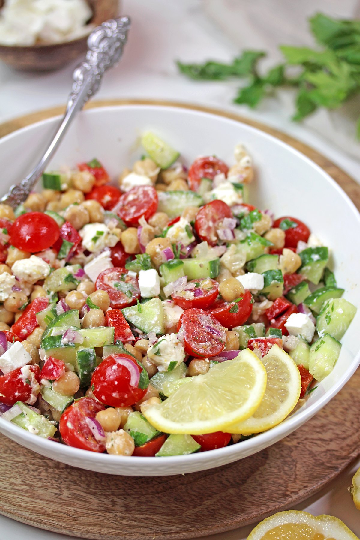 Mediterranean Chickpea Salad with feta, cucumber, tomatoes, and lemon dressing.