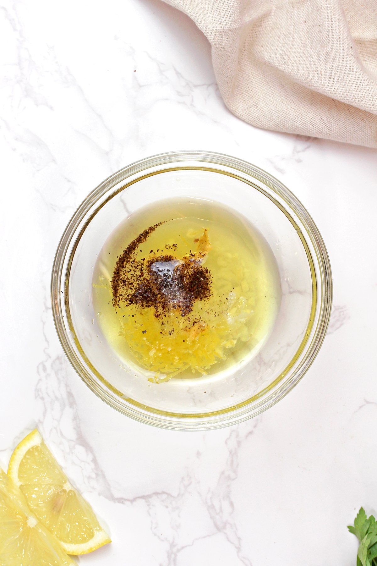 Lemon dressing made with olive oil, Dijon mustard, lemon juice, garlic, salt, and pepper for Mediterranean chickpea salad.