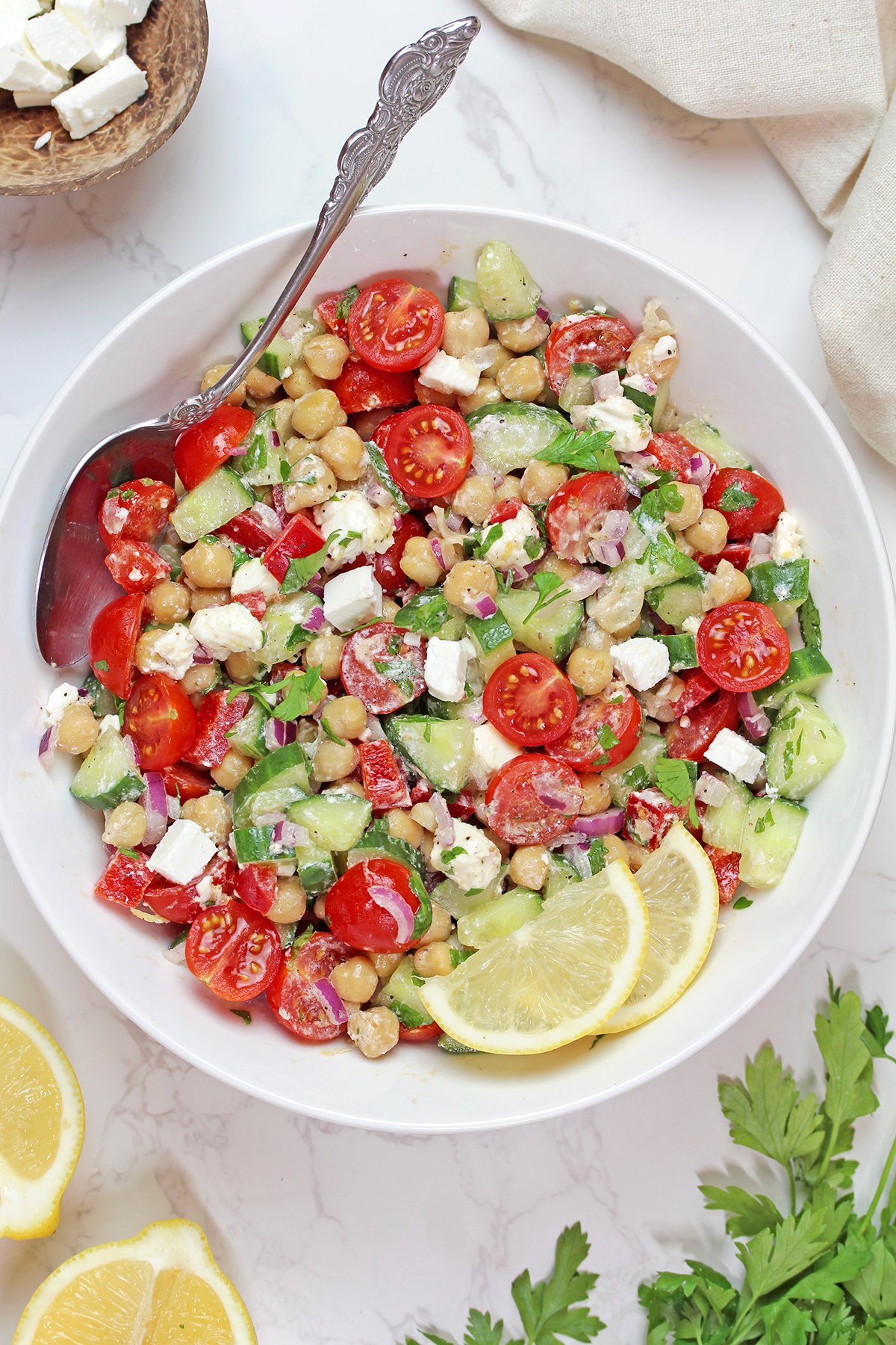 Mediterranean Chickpea Salad with feta, cucumber, tomatoes, and lemon dressing.