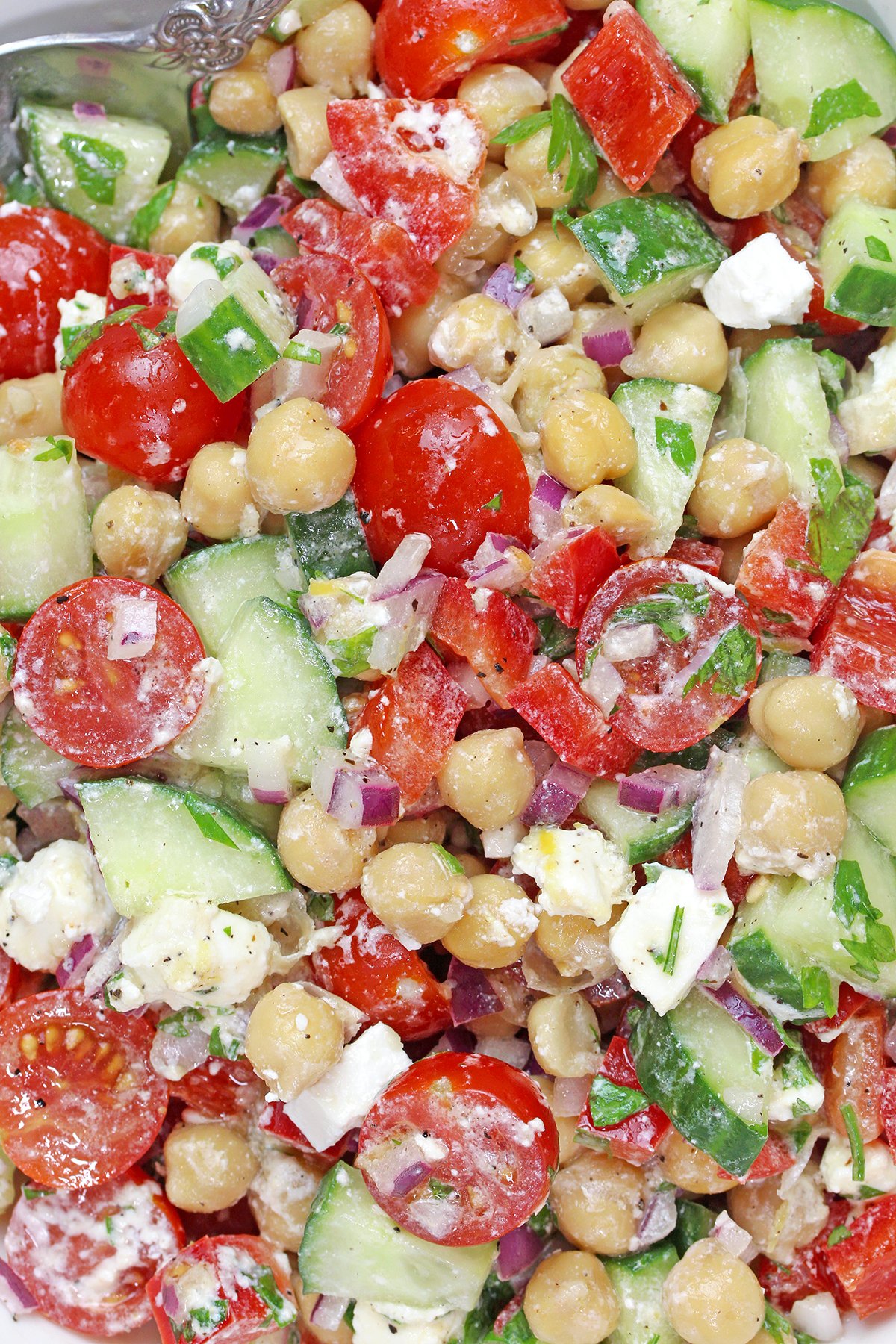 Mediterranean Chickpea Salad with feta, cucumber, tomatoes, and lemon dressing.