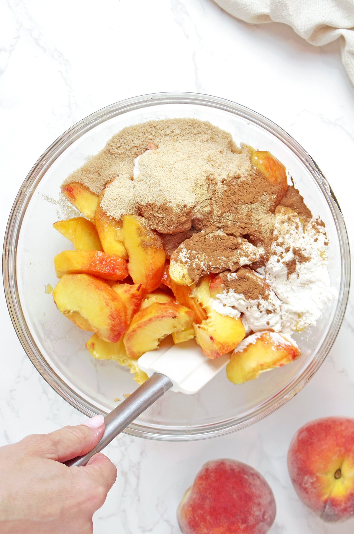 Step 2 - Preparing the peach filling
Sliced fresh peaches mixed with brown sugar, cinnamon, ginger, nutmeg, lemon juice, and vanilla.