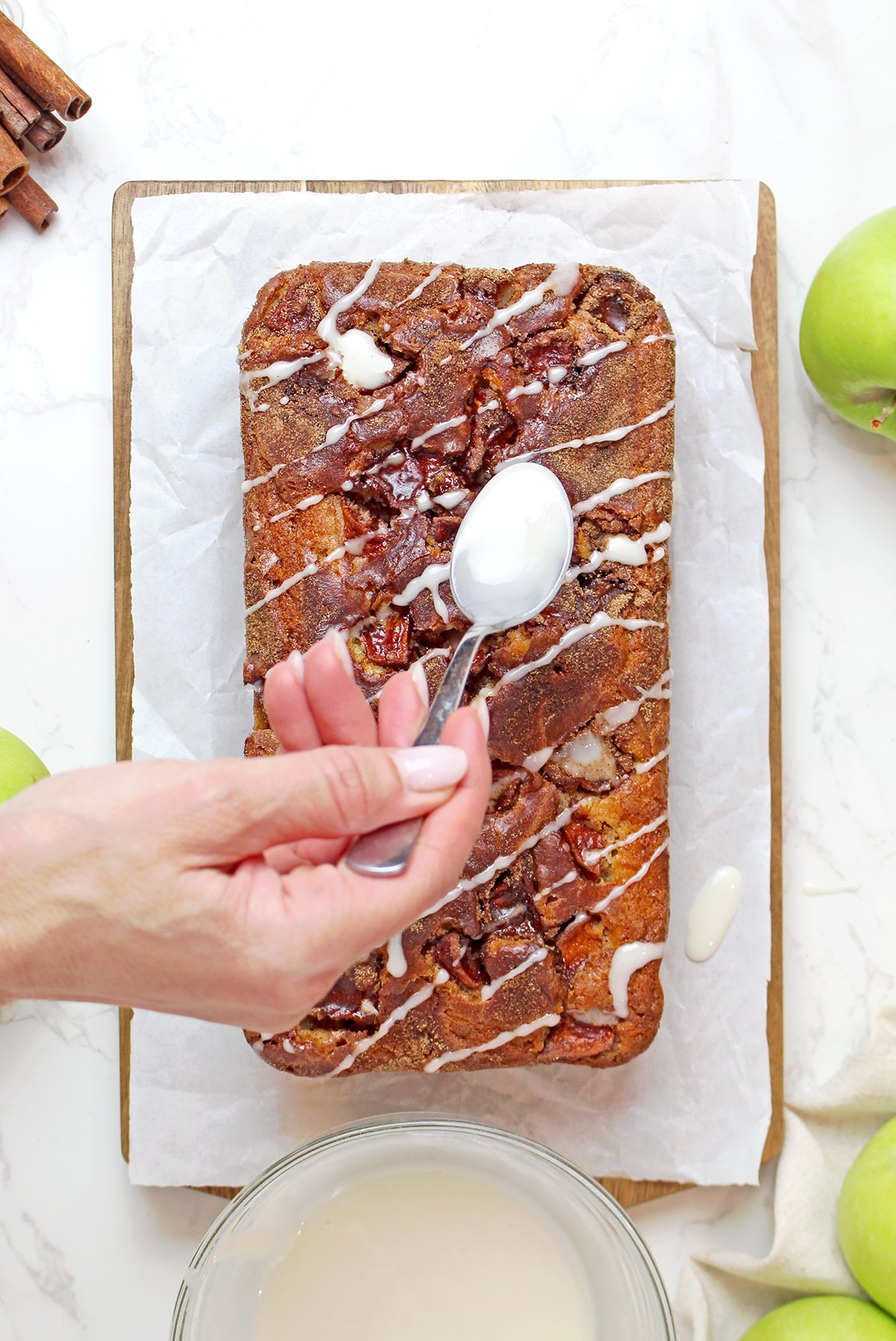 Step 6 - Drizzling sweet glaze over sliced apple cinnamon bread.