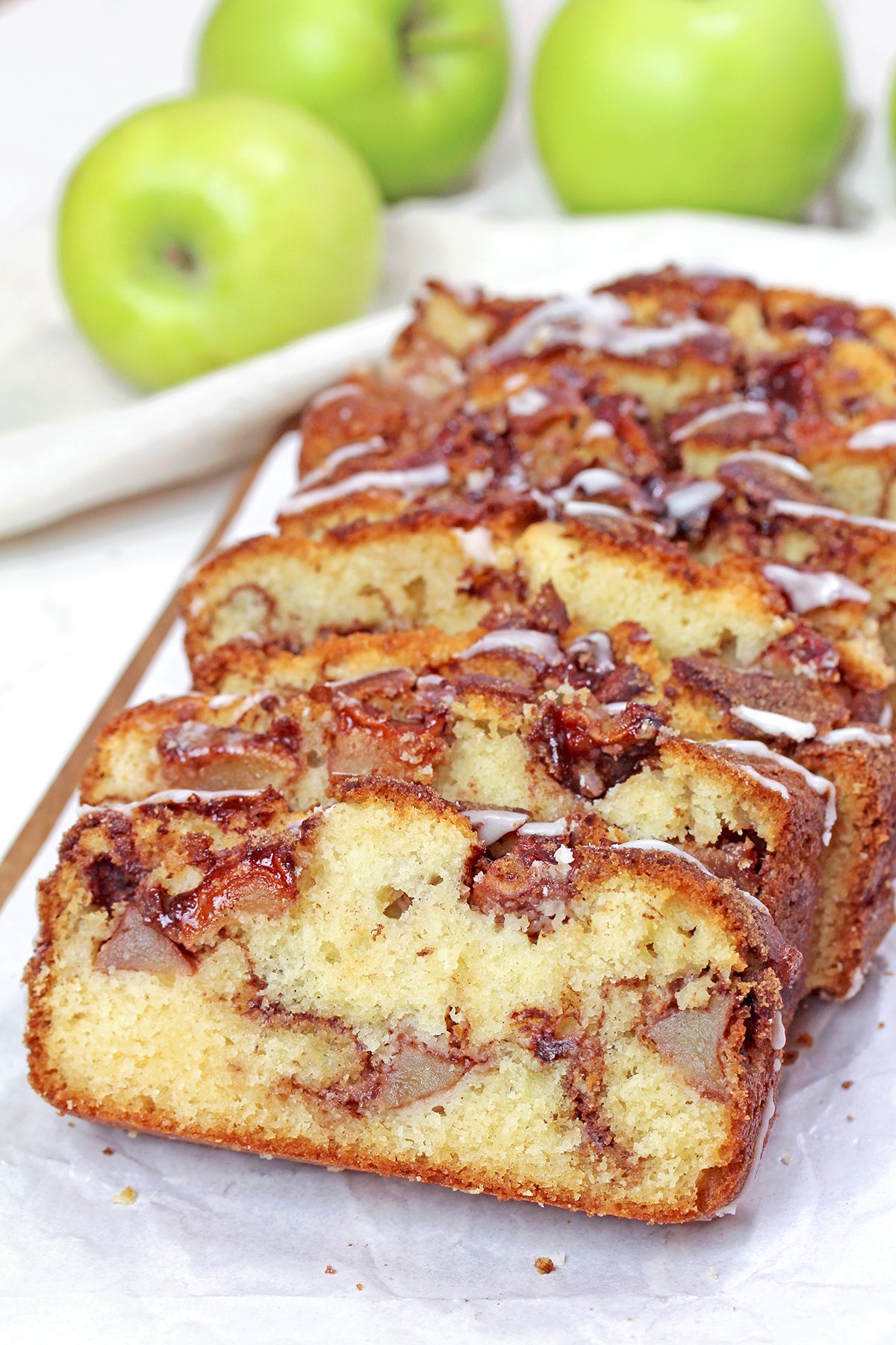 Freshly baked and sliced apple bread with tender apple pieces.