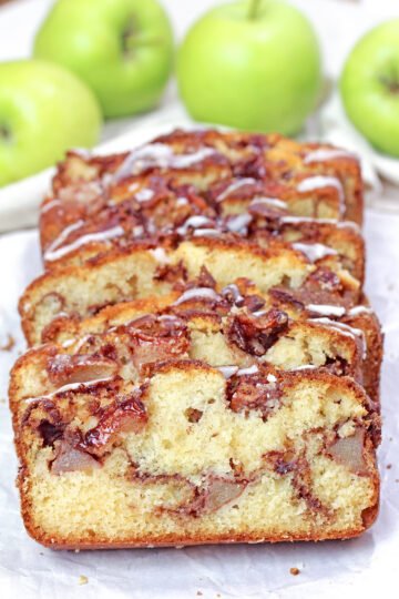 Sliced apple cinnamon bread with tender apple pieces and cinnamon sugar layers.