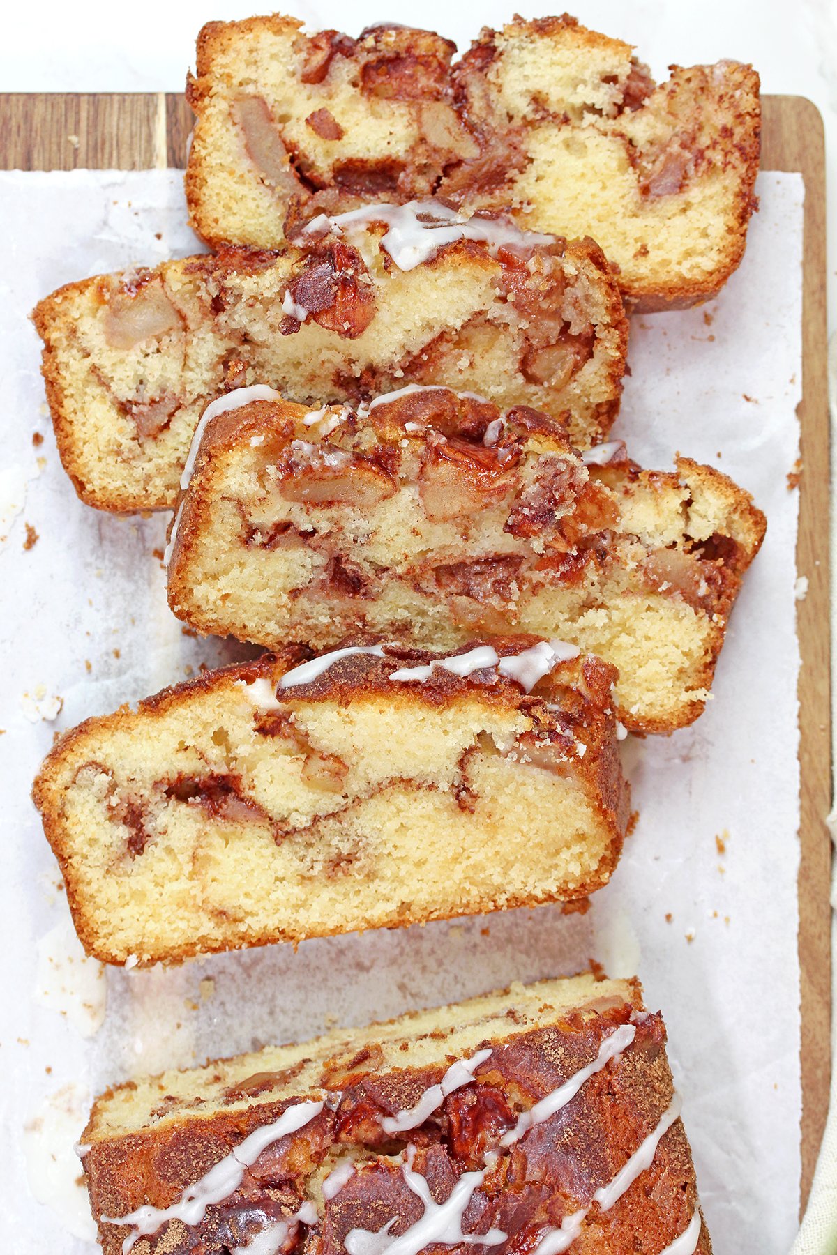 Sliced bread showing tender apple pieces and cinnamon sugar layers.