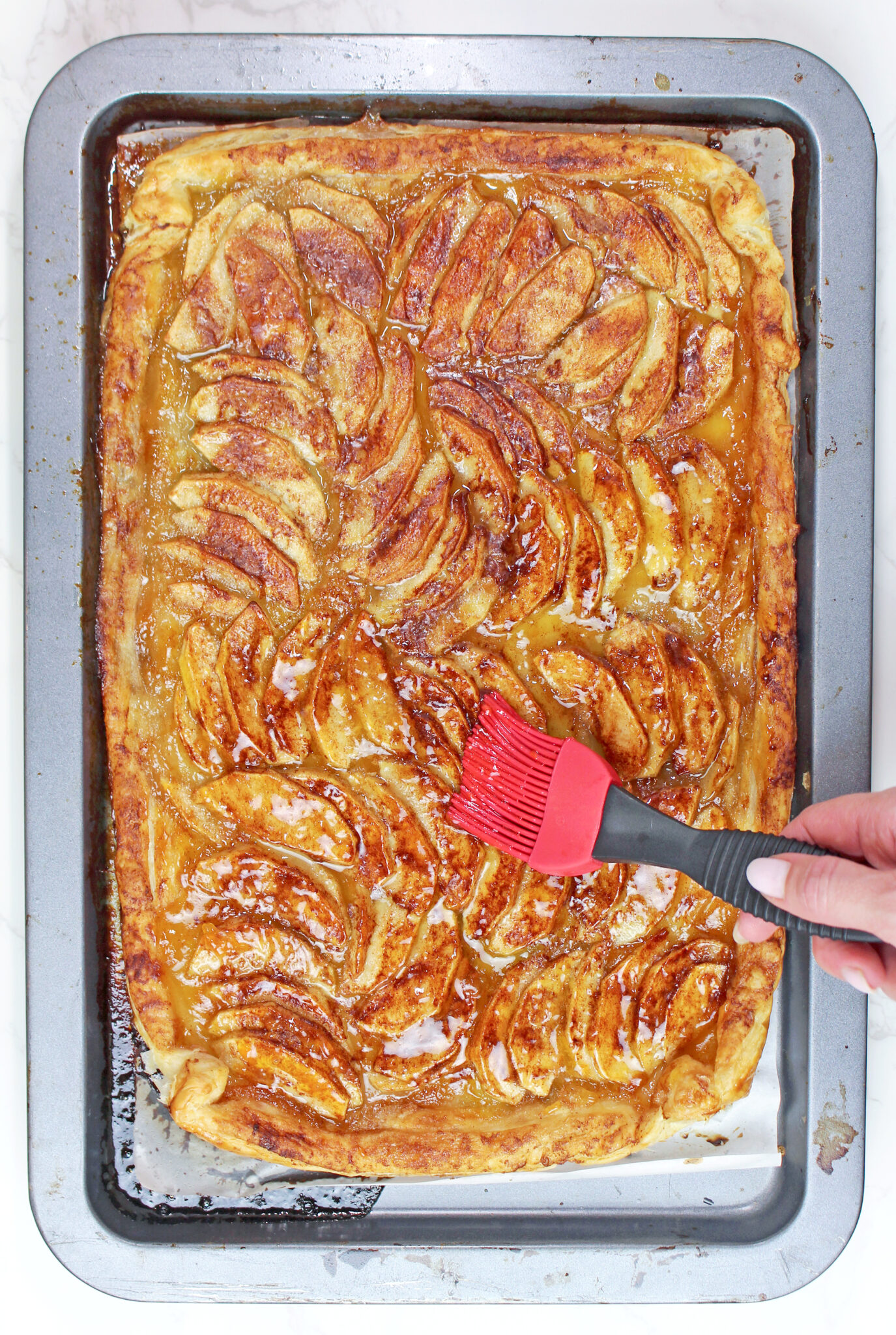 Brush the exposed puff pastry border with beaten egg. Fold the edges slightly over the apples for a more rustic look.