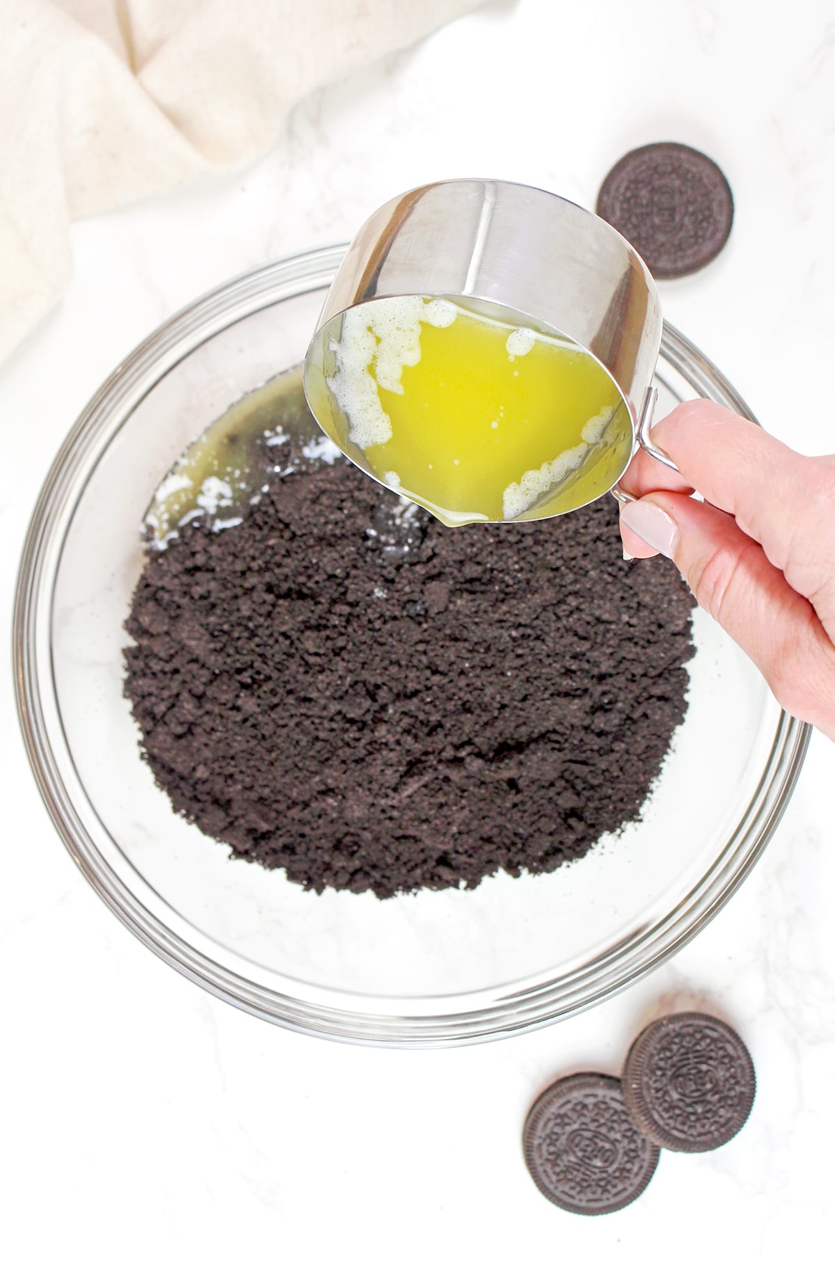 Pressing buttery Oreo cookie crumbs into a pie pan to make the chocolate crust for Mississippi Mud Pie.
