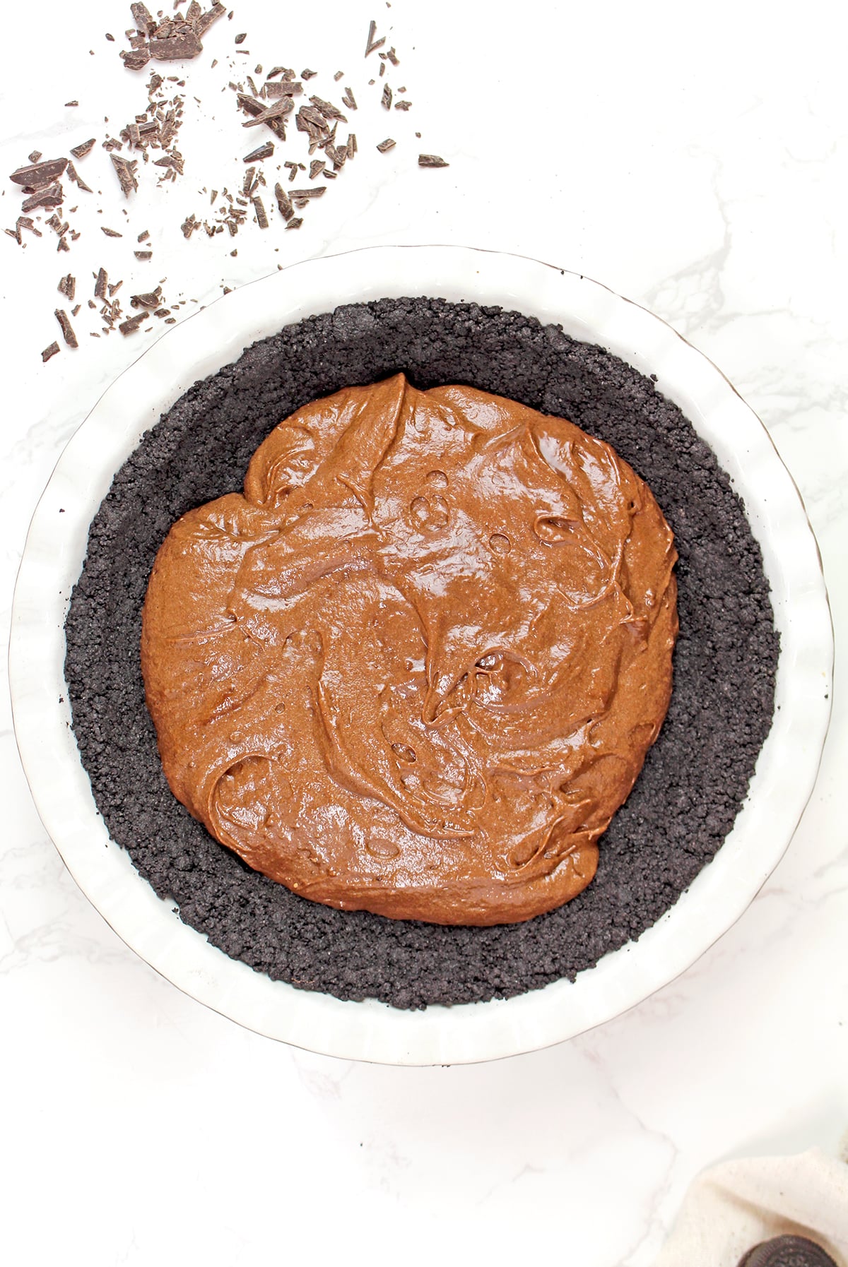 Mixing melted chocolate, eggs, sugar, flour, and cocoa powder to make brownie batter for Mississippi Mud Pie.